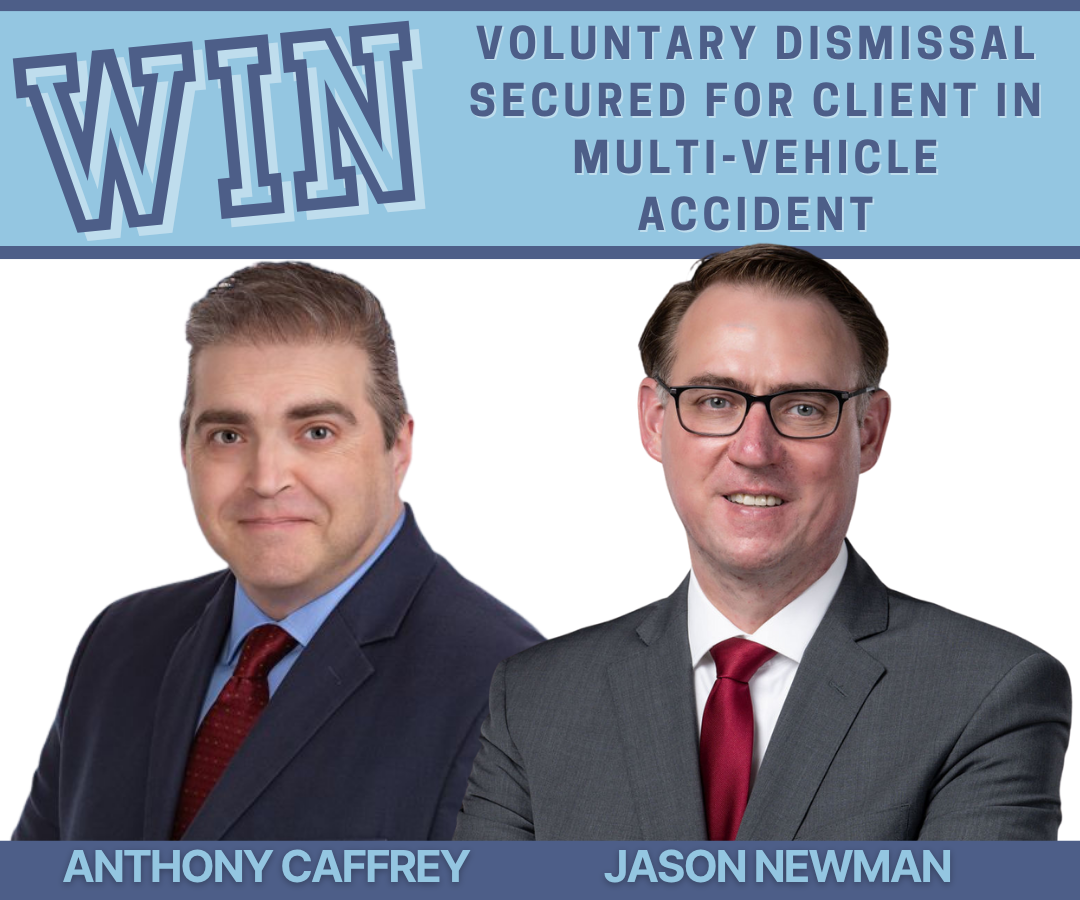 Attorneys Anthony Caffrey and Jason Newman pictured side by side beneath a banner reading 'WIN – Voluntary Dismissal Secured for Client in Multi-Vehicle Accident.' Both are wearing professional suits and smiling confidently, representing their successful defense result.